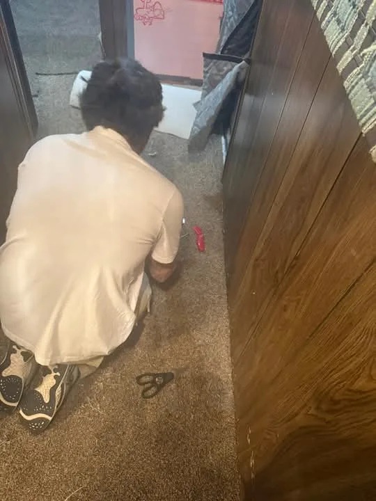 David working on a floor during a home project in Omaha