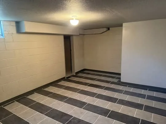 Finished basement floor with tile banding