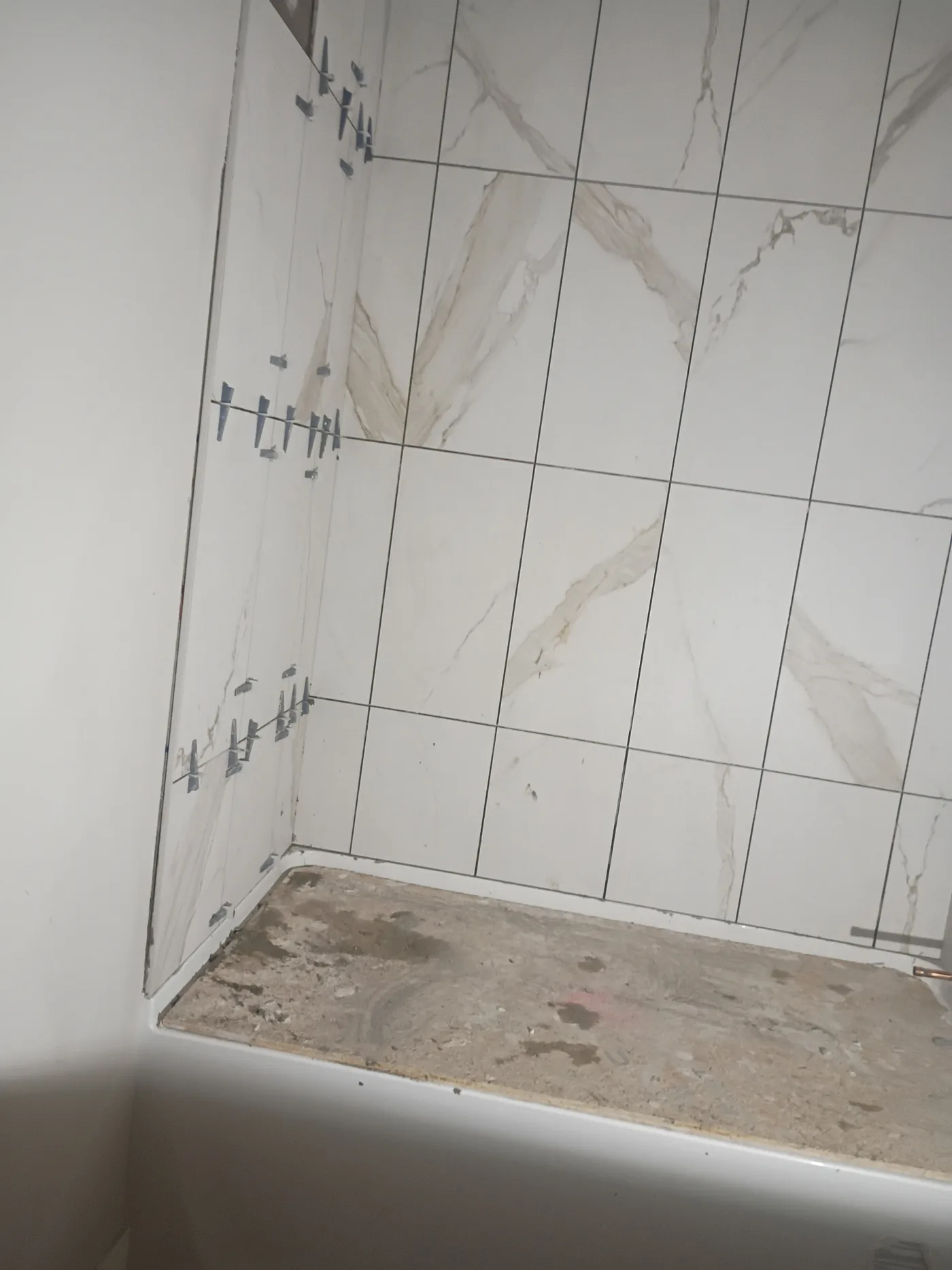Newly tiled shower walls and pan
