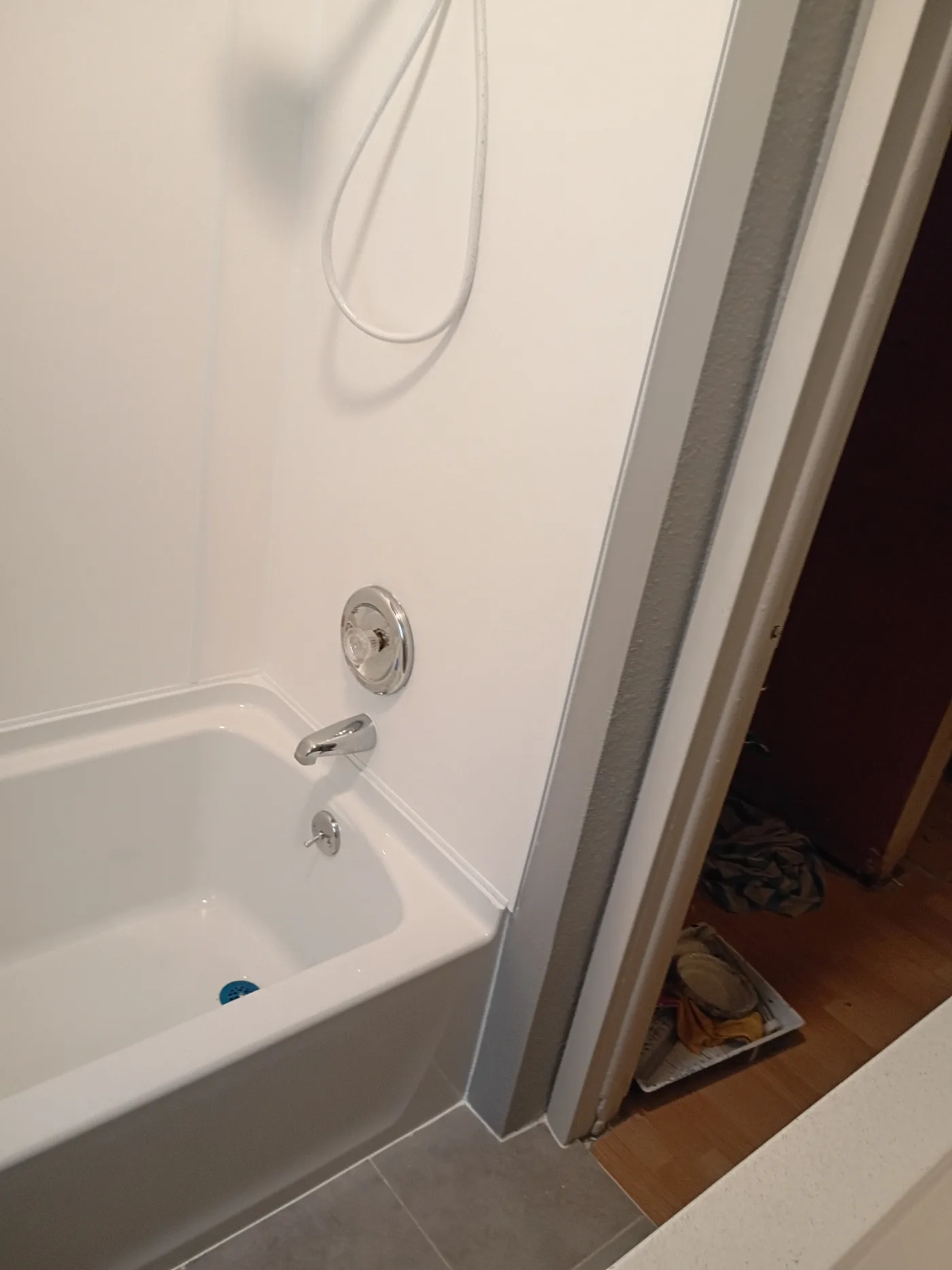 New white bathtub installed in a finished bathroom